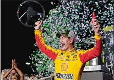  ?? TERRY RENNA/AP PHOTO ?? Joey Logano waves his steering wheel as confetti flies after winning the NASCAR Cup race on Sunday at the Homestead-Miami Speedway.