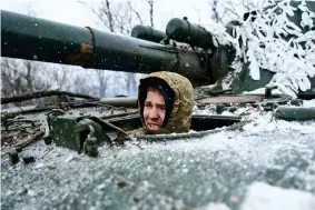  ?? ?? A Ukrainian soldier looks out of a self-propelled artillery vehicle on the frontline, Donetsk region, Ukraine, Saturday, Feb. 18, 2023. (AP Photo/Libkos)