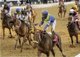  ?? JEFF ROBERSON / ASSOCIATED PRESS ?? Luis Saez rides Secret Oath (center front) across the finish line to win the 148th running of the Kentucky Oaks horse race at Churchill Downs on May 6, in Louisville, Ky.