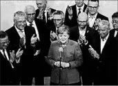  ?? MATTHIAS SCHRADER/AP ?? Party board members applaud German Chancellor Angela Merkel’s success after national elections Sunday in Berlin.