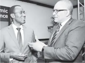  ?? IAN ALLEN/PHOTOGRAPH­ER ?? Dr Nigel Clarke (left), minister of finance and the public service, and Brian Wynter, governor of the Bank of Jamaica, exchange ideas during a function at The Jamaica Pegasus last Thursday.