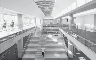  ??  ?? A large wooden staircase connects the two new floors in Vancouver's Central Library.