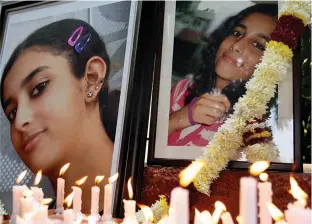  ?? — PTI ?? In this file photo friends and relatives of Aarushi Talwar light candles near her portrait to seek justice for her, at Jantar Mantar in New Delhi. The Allahabad high court on Thursday acquitted her parents Rajesh and Nupur Talwar in her murder case.