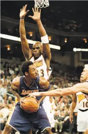  ?? D. Ross Cameron / Associated Press 2000 ?? Kobe Bryant works against Antawn Jamison on Dec. 6, 2000, when each man scored 51 points.