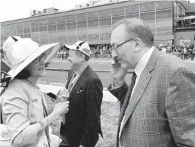  ?? DON MARKUS/BALTIMORE SUN ?? Seth Klarman and his wife, Beth, receive a congratula­tory phone call after Klarman’s horse, Cloud Computing, won the Preakness.