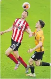  ??  ?? Sheffield United’s Chris Basham, left, and Wolves’ Diogo Jota challenge for the ball.