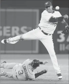  ?? Getty Images ?? Toronto’s Yunel Escobar gets the out on Tampa Bay’s Evan Longoria and then throws to complete the double-play at the Rogers Centre on Tuesday night.