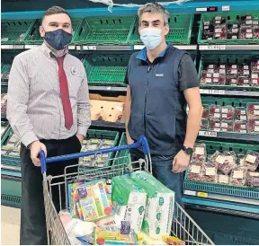  ?? ?? Food for thought Kevin Stevenson (left) was delighted to hand over donations to James from the St Vincent Du Paul food bank