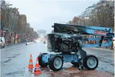  ??  ?? A burnt crane is seen near the Arc de Triomphe on the Champs-elysees avenue in Paris. — AFP
