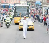  ?? ?? Trevor Madigan with the torch in Forfar.