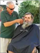  ?? CHRIS BARBER — DIGITAL FIRST MEDIA ?? Barber Jack Assetto begins the shave of Tom Murphy’s 44-yearold beard.