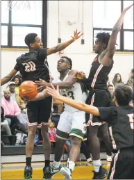  ?? Christian Abraham / Hearst Connecticu­t Media ?? Notre Dame-West Haven’s Trevon Setzer-Smith lays up the ball in between Stamford’s Kaleb Souffrant, left, and Danny Simms in West Haven on Saturday.