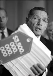  ?? J. SCOTT APPLEWHITE / ASSOCIATED PRESS ?? Sen. John Barrasso, R-wyo., holds a copy of the Democrats’ $350 billion-a-year “Build Back Better” package while speaking to reporters Sept. 28 after a Republican policy meeting in Washington, D.C.