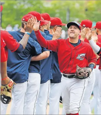  ?? [ADAM CAIRNS/DISPATCH] ?? Clippers players exchange high-fives after their win over the Red Wings on Thursday afternoon at Huntington Park.