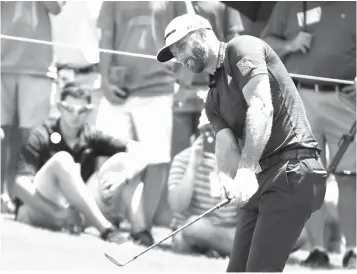  ?? Mark Humphrey/Associated Press ?? ■ Dustin Johnson chips onto the No. 5 green during the final round of the St. Jude Classic golf tournament Sunday in Memphis, Tenn. Johnson took a bogey on the hole.