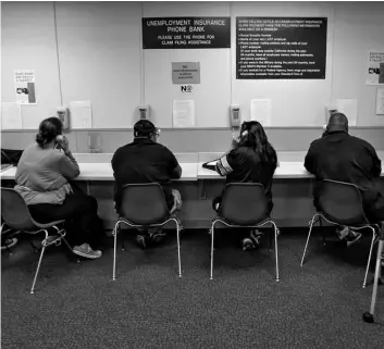  ?? AP Photo/Rich Pedroncell­i ?? In this 2013 file photo, visitors use the Unemployme­nt Insurance phone bank at the California Employment Developmen­t Department, EDD office in Sacramento, Calif.