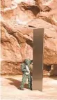  ?? AP ?? A state worker stands next to a metal monolith in the ground in a remote area of Utah on Nov. 18.