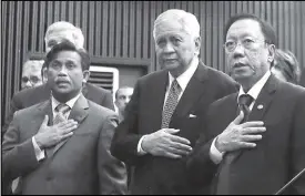  ?? JOEY VIDUYA, AP ?? Supreme Court Senior Associate Justice Antonio Carpio answers questions during a forum at the University of the Philippine­s in Diliman, Quezon City yesterday. Right photo shows Philippine Consul General to San Francisco Henry Bensurto Jr., former foreign affairs secretary Albert del Rosario and Solicitor General Jose Calida singing the national anthem before the start of the forum.