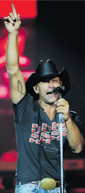  ?? BRUCE EDWARDS/EDMONTON JOURNAL) ?? Tim McGraw flexes his vocal chords for the crow at Edmonton’s Rexall Place ion Tuesday.