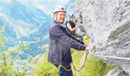  ??  ?? Buckled up as we embark on the cliffside cableway called the via ferrata in Switzerlan­d’s Berner Oberland.