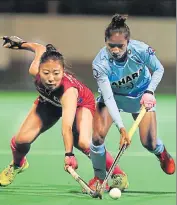  ??  ?? Nikki Pradhan (right) tries to dribble past a Japanese player on Friday. HI PHOTO