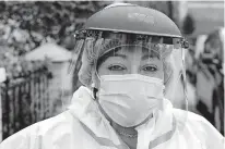  ?? [FRANK FRANKLIN II/ THE ASSOCIATED PRESS] ?? Linda Silva, a nurse's assistant, poses for a portrait, Thursday, in the Queens borough of New York. Silva, who tested positive for COVID-19, returned to work after recovering. It's been more than a month since she has hugged her two sons or her husband.