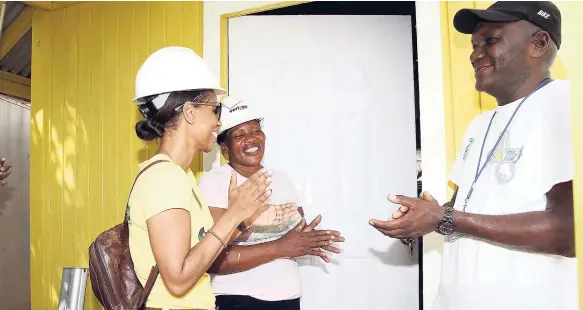  ??  ?? Food-For the Poor-house beneficiar­y, Beverly Foote opens the door of her brand-new two-bedroom house for the first time in Irish Pen, Spanish Town, St Catherine, on Thursday, July 20. Sharing in the moment are Supreme Ventures Assistant Vice-President,...