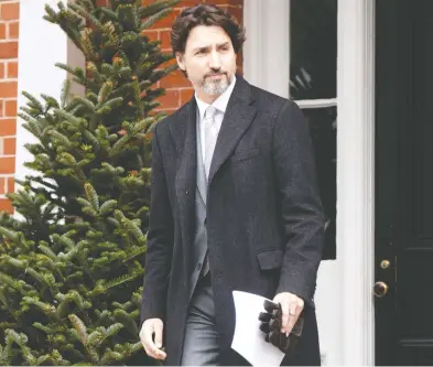  ?? ADRIAN WYLD / THE CANADIAN PRESS ?? Prime Minister Justin Trudeau steps out of Rideau Cottage for a daily briefing with the media in Ottawa on Friday.