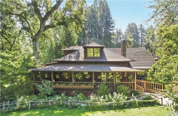  ?? Open Homes Photograph­y ?? A front porch and stone chimney accent the three-bedroom farmhouse that dates back to 1895 at 7390 Sonoma Mountain Road in Glen Ellen.