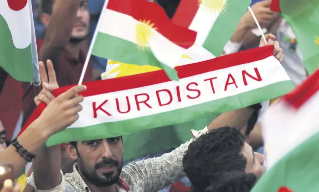  ??  ?? Iraqi Kurds fly Kurdish flags during an event to urge people to vote in the upcoming independen­ce referendum in Irbil, the capital of the KRG, on Sept. 16.