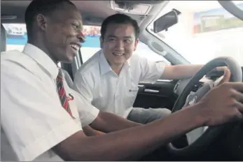  ?? PROVIDED TO CHINA DAILY ?? A potential Kenyan buyer takes driver’s seat to test-drive BAIC’s new truck model under the guidance of a Chinese salesperso­n in Nairobi, Kenya.