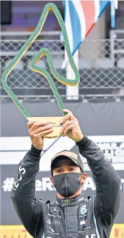  ?? Shuttersto­ck. ?? Lewis Hamilton with the Styrian GP silverware after winning the second race of the season by 13.7 seconds.
