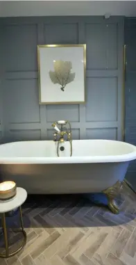  ??  ?? RIGHT: Panelling, a welcome change from the usual tiled surfaces, in this bathroom in interior designer Sinead Considine’s home, adds texture and warmth. Sinead added depth by painting the roll-top bath in the same shade as the panelling