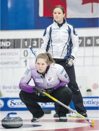  ??  ?? Skips Kesa Van Osch and Karla Thompson, back, watch a throw during playoff action at the B.C. Scotties women's provincial curling championsh­ip at the Victoria Curling Club on Saturday.