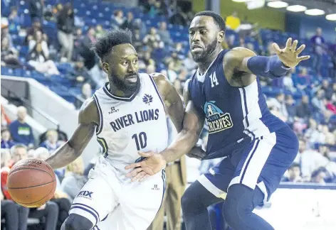  ?? JULIE JOCSAK/STANDARD STAFF ?? Omar Strong of the Niagara River Lions tries to get the ball past Antoine Mason of the Halifax Hurricanes in basketball action at Meridian Centre in St. Catharines Wednesday night.