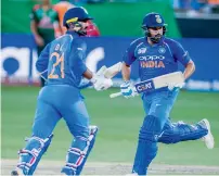  ??  ?? Rohit Sharma (right) and Dinesh Karthik steal a single in the final.