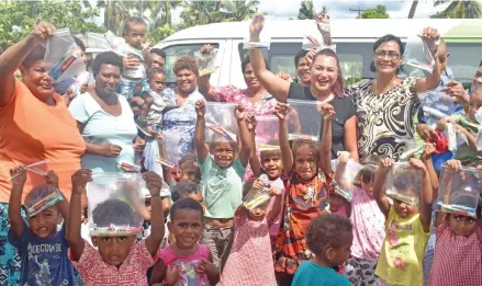  ?? Photo: Arieta Vakasukawa­qa ?? Flavours of Fiji Cooking School Director, Malisa Raffe (wearing black) after handing children 100 toothbrush­es and 100 toothpaste tubes from Champs on Wheels (Mobile Kindy) at Nawaka Village in Nadi on March 22, 2018.