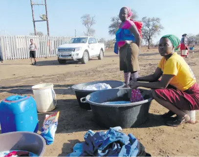  ?? Picture: Alex Matlala ?? SCARCE RESOURCE. People in the Mopani District Municipali­ty use one communal tap for water from a borehole drilled by Khato Civils.