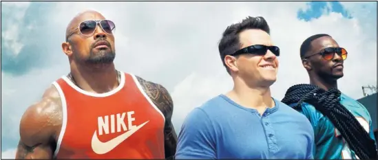  ??  ?? From left, Dwayne Johnson is Paul Doyle, Mark Wahlberg is Daniel Lugo and Anthony Mackie is Adrian Doorbal in “Pain & Gain.”