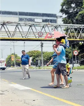  ?? LUIS RODRÍGUEZ ?? Peatones cruzan la Avenida Circunvala­r, puesto que el puente está inconcluso.