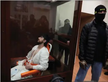  ?? ALEXANDER ZEMLIANICH­ENKO — THE ASSOCIATED PRESS ?? Mukhammads­obir Faizov, a suspect in Friday’s shooting at the Crocus City Hall, sits in a glass cage in the Basmanny District Court in Moscow, Russia, March 24.