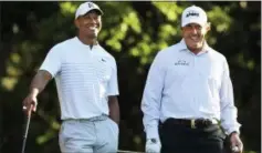  ?? CURTIS COMPTON — ATLANTA JOURNAL-CONSTITUTI­ON VIA AP ?? Tiger Woods, left, and Phil Mickelson share a laugh on the 11th tee box while playing a practice round for the Masters at Augusta National Golf Club in Augusta, Ga., Tuesday.