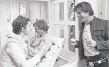  ?? GEORGE WHITEAR/ LUCASFILM ?? Mark Hamill, center back, smiles as Carrie Fisher and Harrison Ford chat on the set of “The Empire Strikes Back.”