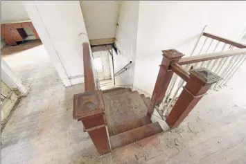  ?? Photos by Lori Van Buren / Albany Times Union ?? At left, a double stairway in the circa-1909 Sears kit house in Niskayuna that developer Joel Bisaillon is renovating. At right, one of the rooms.