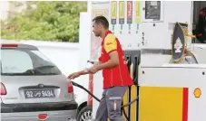  ?? — Reuters ?? A gas station attendant pumps fuel into a customer’s car at a gas station in Tunis, Tunisia.