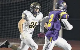  ?? Jenn March / Special to the Times Union ?? Averill Park defensive back James Finelli chases as Troy running back Xavier Leigh runs scores a touchdown on Friday in Troy.