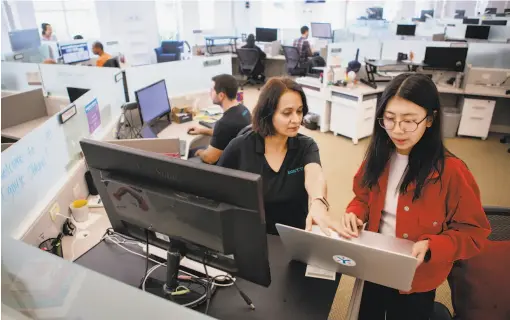  ?? Photos by Santiago Mejia / The Chronicle ?? Egnyte's analyst relations director Chhavi Ahuja (left) works with data analyst Beichuan Liu at the company headquarte­rs in Mountain View.