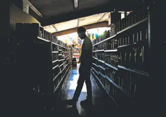  ?? Jessica Christian / The Chronicle ?? Customers shop at La Tapatia Market in Napa during PG&E’s power shutoffs in October.