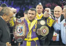  ?? ASSOCIATED PRESS FILE PHOTO ?? Vasiliy Lomachenko celebrates defending his WBA/WBO lightweigh­t titles after knocking out Anthony Crolla, in Los Angeles.
