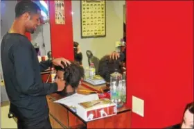  ?? DIGITAL FIRST MEDIA FILE PHOTO ?? In this file photo, a student practices on a mannequin head of hair at a practice station for Antonelli Medical & Profession­al Institute’s barber program — launched in July 2017. In August, the school announced it would close — a decision it reversed...